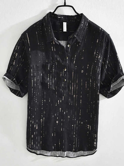 Black short-sleeve shirt with subtle pattern on a white background