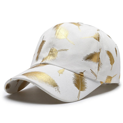 White cap with gold leaf pattern on a white background