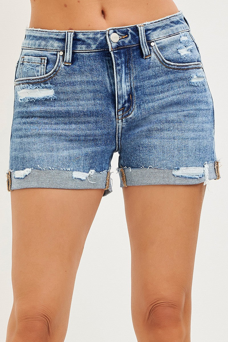 Blue denim shorts with distressed details on a white background