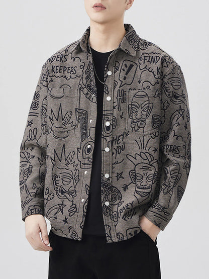 Person wearing a patterned long sleeve button down shirt with various designs on a plain background