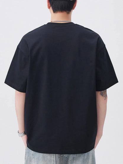 Person wearing a black t-shirt on a plain background