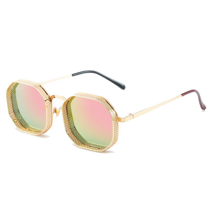 Sunglasses with gold frame and pink-tinted lenses on a white background