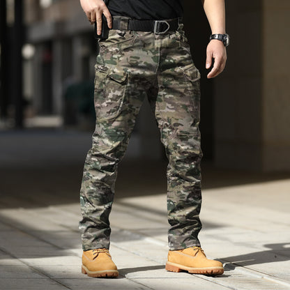 Person wearing camouflage pants and tan boots on a blurred background