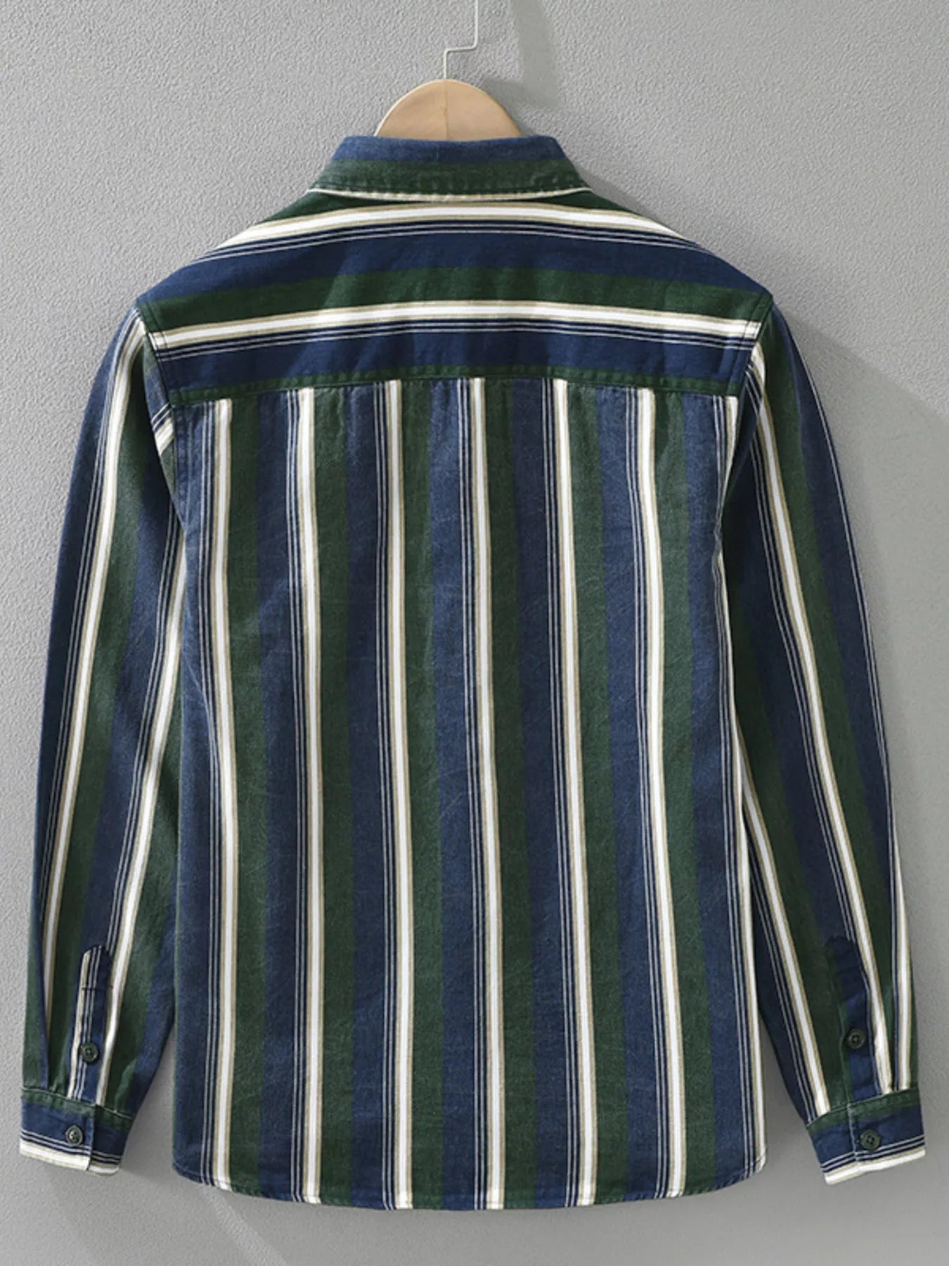 Striped shirt with green, white, and blue pattern on a gray background