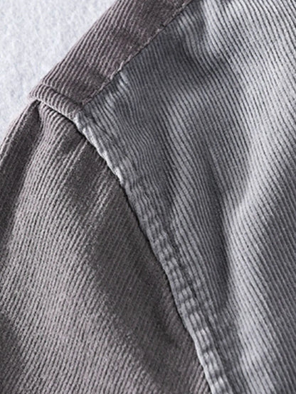 Close-up of gray corduroy fabric with a visible seam