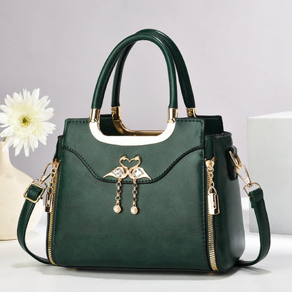 Handbag with gold accents with a single flower and white background.