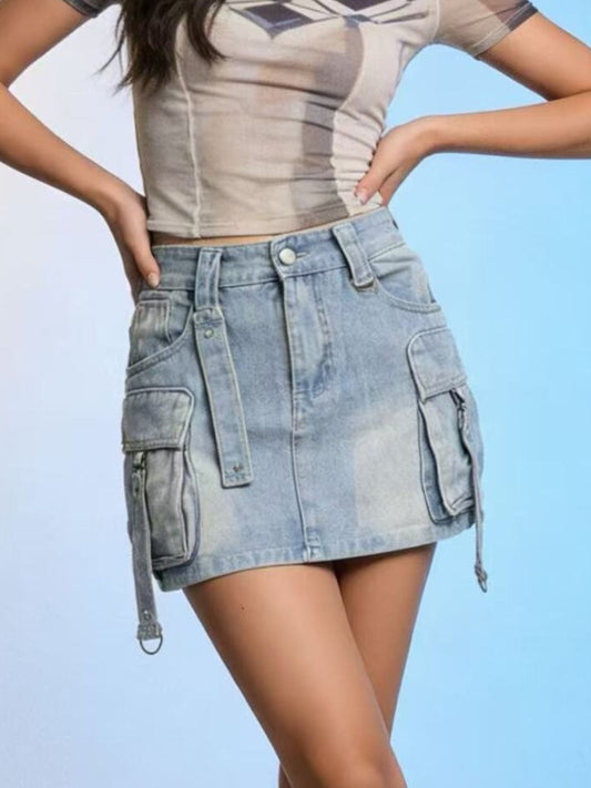 Person wearing a beige crop top and denim skirt against a light blue background