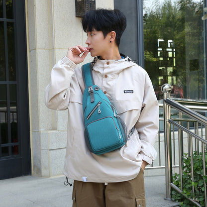 Person wearing a beige jacket with a blue backpack outdoors.