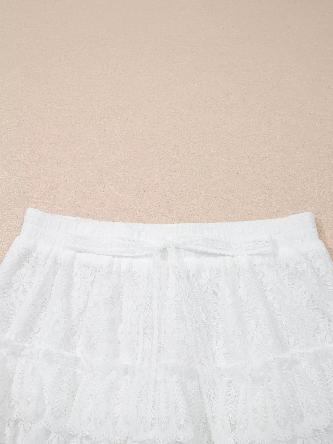 Close-up of white pants on a beige background