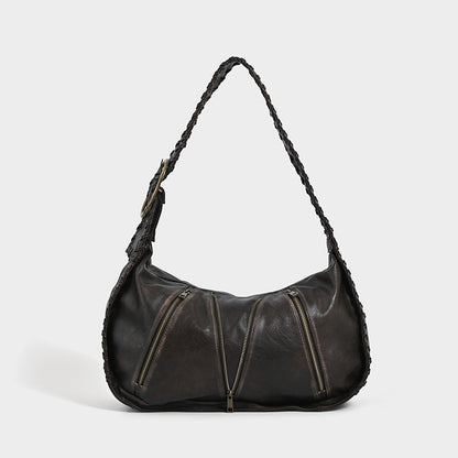 Shoulder bag with zipper details on a white background.