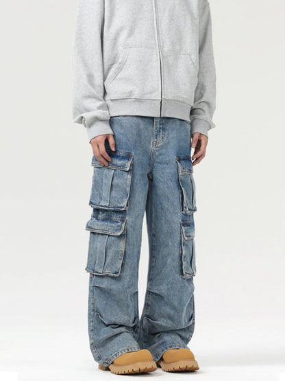 Person wearing a gray hoodie and blue cargo pants on a white background