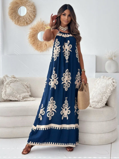 Woman wearing a blue dress with white patterns in a living room setting.