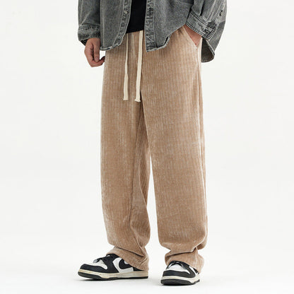 Person wearing beige corduroy pants with a plain background
