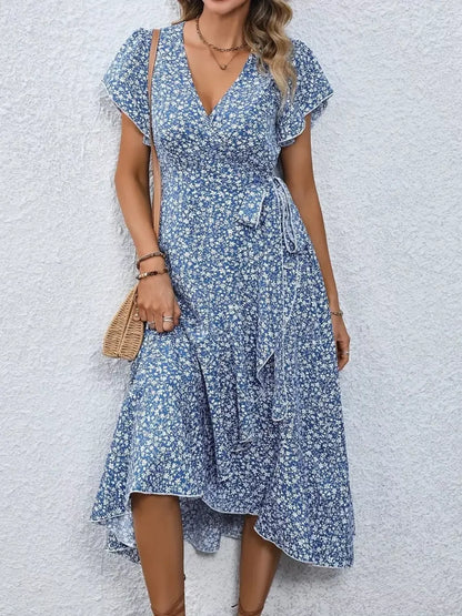 Woman wearing a blue floral dress against a light background