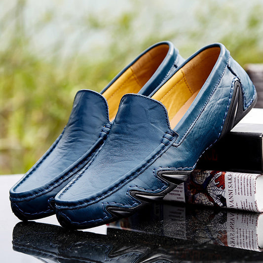 Blue loafers with a blurred green background