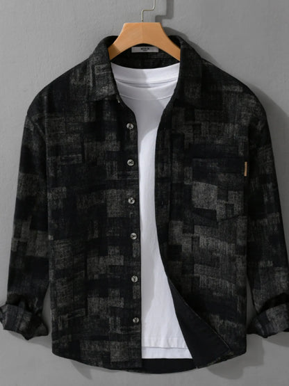 Black checkered shirt over a white t-shirt on a hanger against a gray background