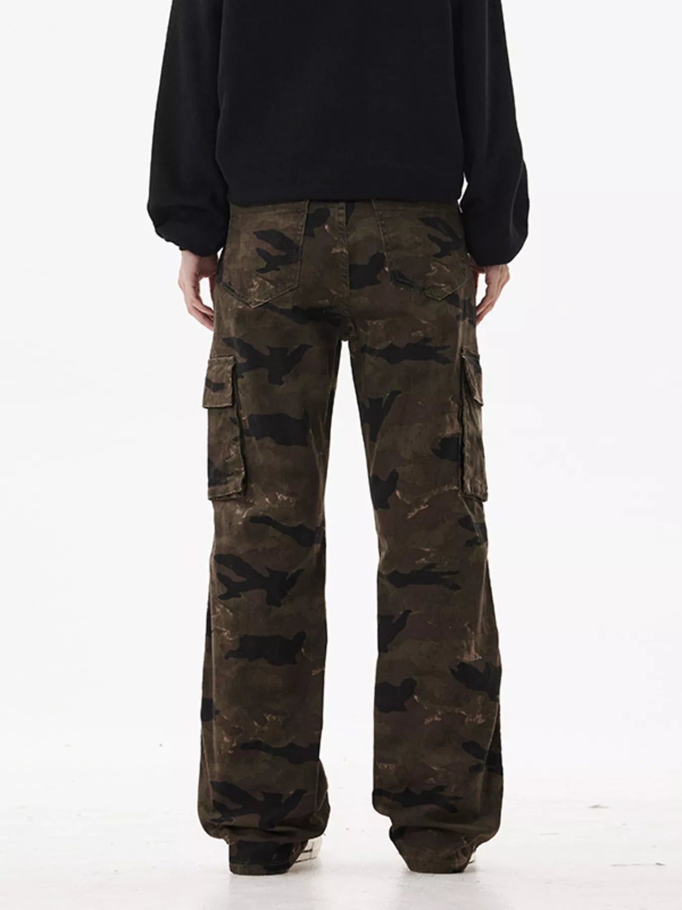 Person wearing camouflage cargo pants on a white background